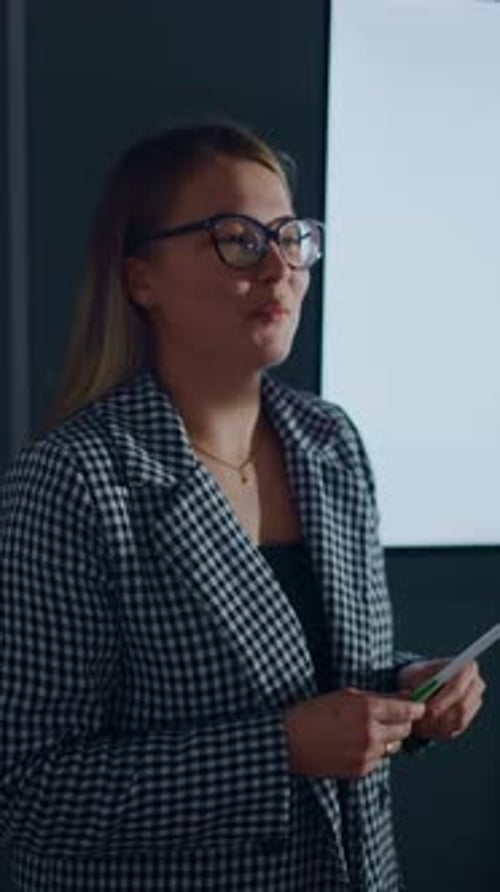 Confident Young Professional Giving a Business Presentation in Modern Office Explaining Analytical