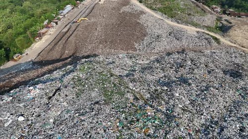 Aerial View of a Landfill Site with Excavator