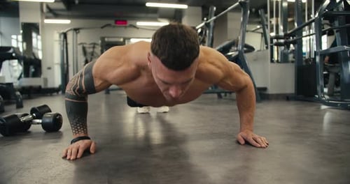 Strong Athletic Man Trains Shirtless in the Gym Doing Pushups Lean Muscular Athlete Staying Healthy