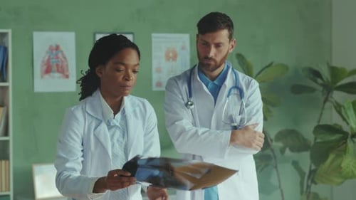 Doctors Examining X-Ray in Hospital Room