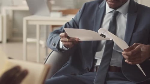 Man Reviews Documents in Office Setting