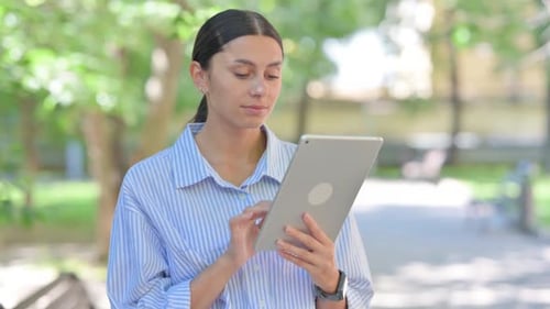 Woman Using Tablet in Urban Outdoor Setting