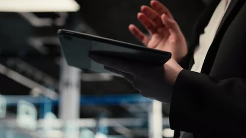 Close Up of Tablet Used By Data Center Admin Troubleshooting Supercomputers