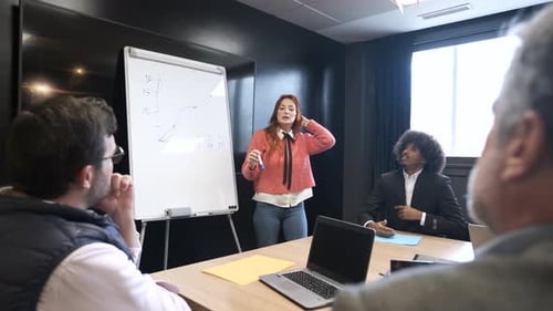 Group of Colleagues Listening to Female Speaker