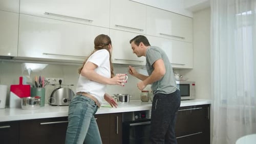 Adults Cooking Together in a Bright Modern Kitchen