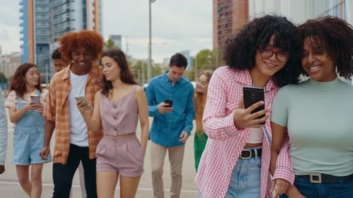 Group of Friends Using Smartphones in the City