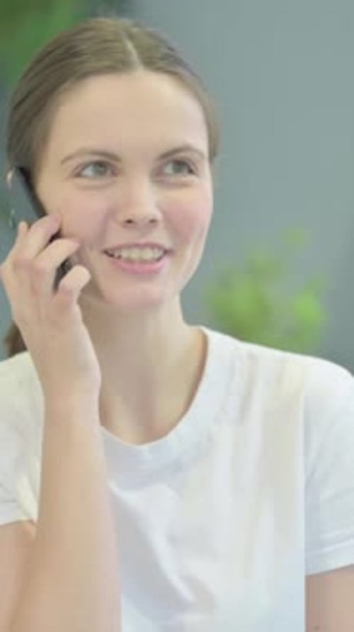 Woman Talking on Phone Indoors in Portrait Orientation
