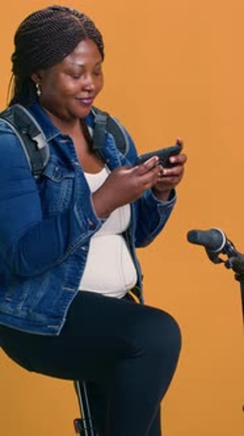 Woman Sits Using Smartphone Next to Microphone