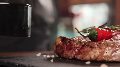 chef cook delicious meat in restaurant