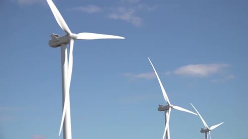 Wind turbines turning in strong winds.