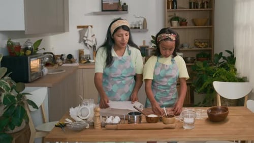 Little Girl Helping Mom to Make Homemade Cookies