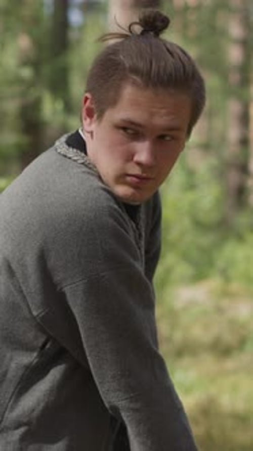 Young Man Does Sword Strikes Training for Battle in Wood