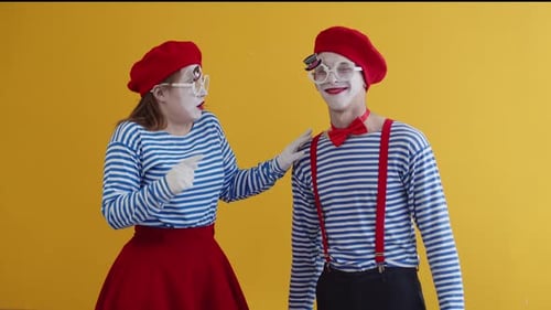 Young Surprised Mime Woman Treats Young Mime Man Like a Fool and Twist Her Finger at the Temple