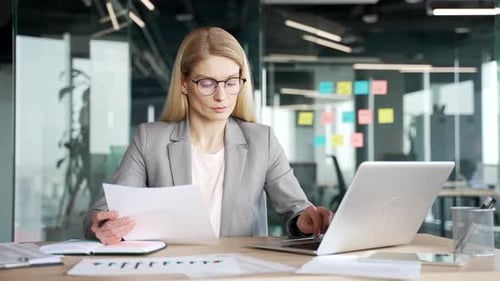 Professional Woman Working on Laptop in Office