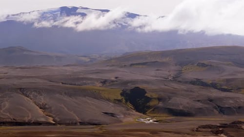 Rugged Terrain of Iceland Showcasing Volcanic Features and a Serene River Landscape