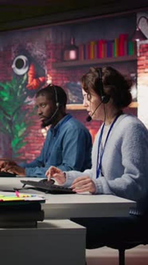 Workers Typing At Desks In Call Center At Night