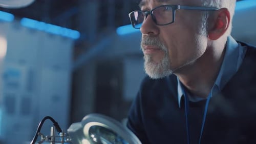 Electronics Maintenance Engineer Enters His Workshop with Coffee Beginss Soldering of Circuit Board