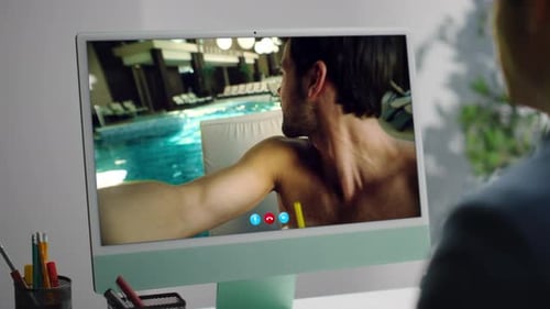 Business Guy Talking Online with Pool Man By Desk Computer in Office Closeup