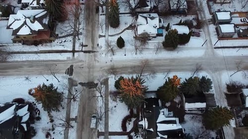 3-5 twilight aerial birds eye view over luxury winter residential homes snowed in roads bare trees h