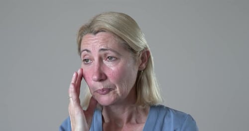 Blonde female agitated with grief and crying