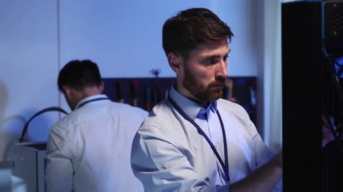 Corporate Teamwork of Two Multiethnic Engineer and Technician Fixing 3D Modeling Printer Advanced