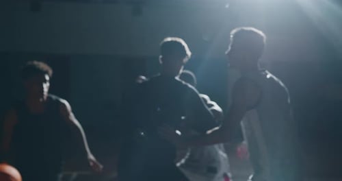 Cinematic slow motion close up shot of young professional male players are practicing a basketball