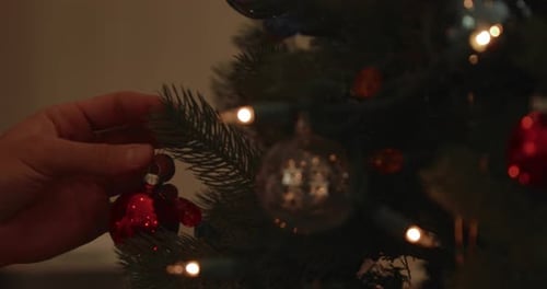 Decorating a Christmas Tree with Festive Ornaments