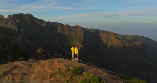 Hikers Admire Mountainous Vista at Sunrise