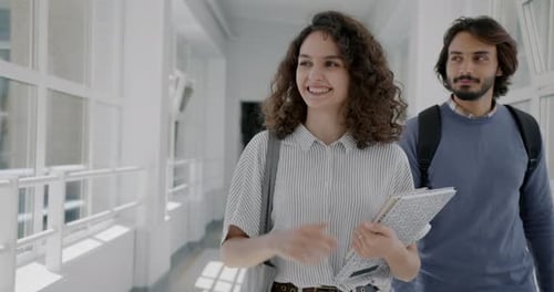 Slow Motion Portrait of Friendly Young Lady Student Walking in High School Hallway Waving Hand
