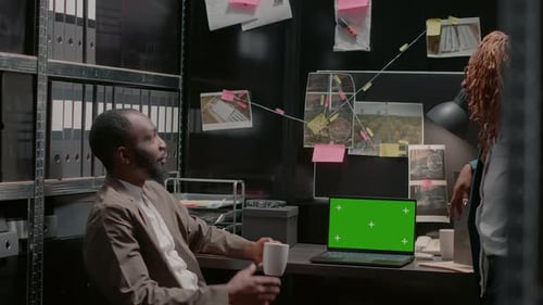 Two Inspectors Using Greenscreen on Laptop at Desk