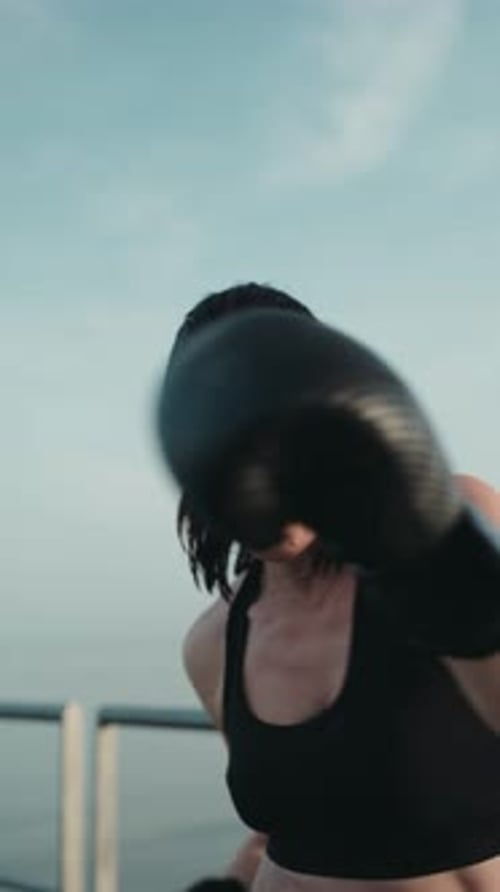 Woman Boxing with Energy Outdoors in the Daytime