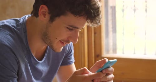 Home, phone and young man typing social media app message, blog post or contact social network user
