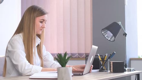 Woman Working on Laptop at Home Office Desk