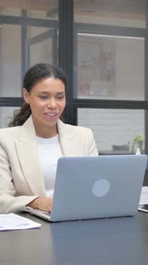 Woman in Blazer Attending Virtual Business Meeting