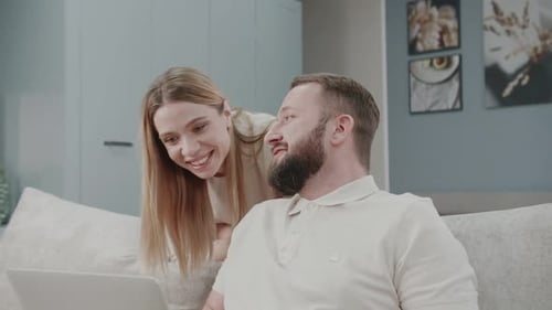 Smiling Couple Using Laptop Together Indoors