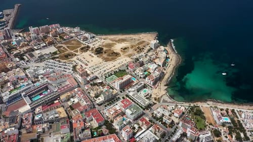 Aerial drone footage of the town of Sant Antoni de Portmany on the west coast of Ibiza in Spain