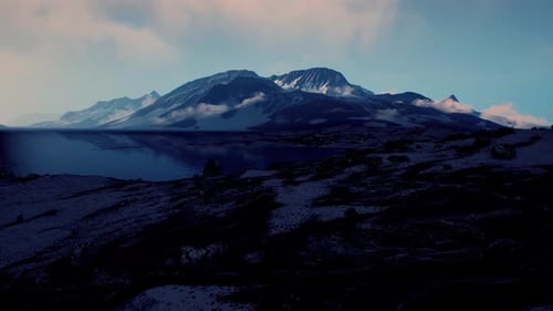 View of a Landscape of a Norwegian Fjord with a Snowy Mountain and Rocks