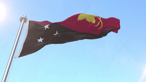 Papua New Guinea Flag Waving against Clear Blue Sky