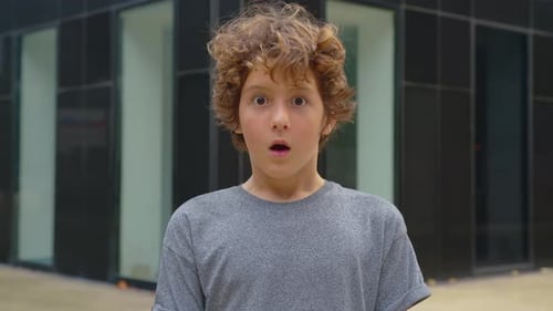 Boy with Curly Hair Expressing Surprise