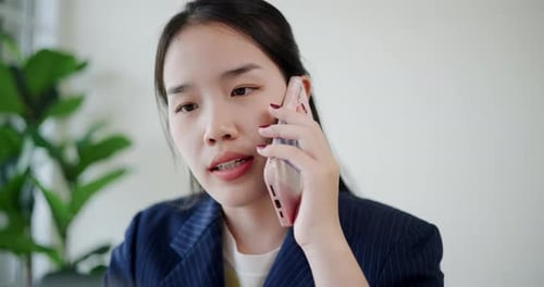 Close-up of businesswoman talking on a mobile phone in the cafe.