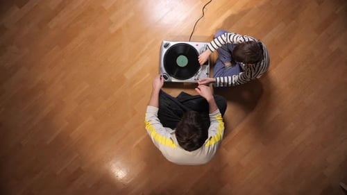 Child and Man Listening to Vinyl on Turntable