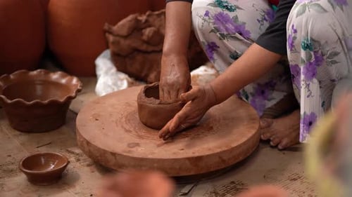 Woman Shaping Clay Pot on Pottery Wheel