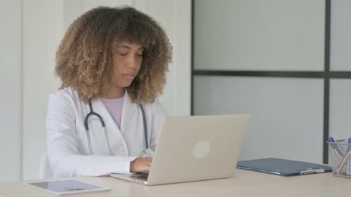 African Female Doctor Smiling at Camera at Work in Clinic