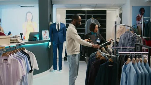 Asian Woman Showing Shirts to Male Client in Mall Store
