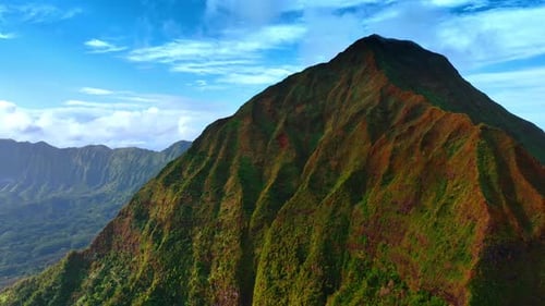Spectacular unapproachable rock covered with green grass and moss.