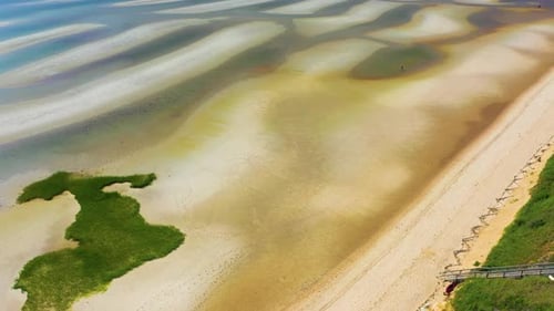 Cape Cod Drone View of Beach at Low Tide with Shimmering Tidal Pools and Dunes