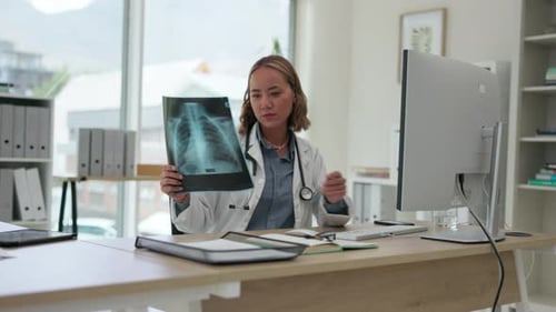 Woman Doctor Examining X-Ray at Desk