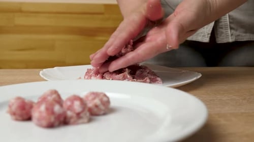 Hands Rolling Ground Meat into Small Meatballs