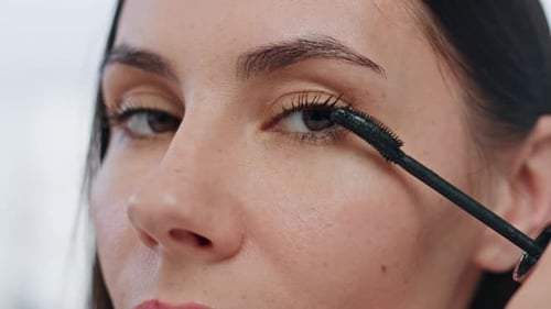 Woman Applies Mascara in Close Up Shot
