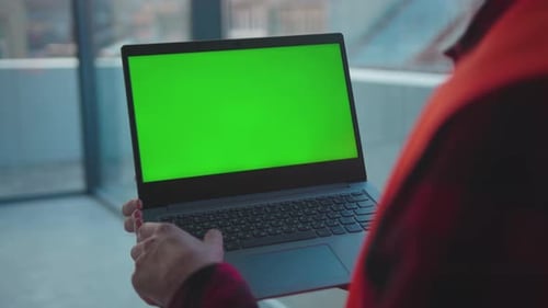 Young Hands Engineer Using Laptop Computer with Green Screen Typing Inside Building Worker Project